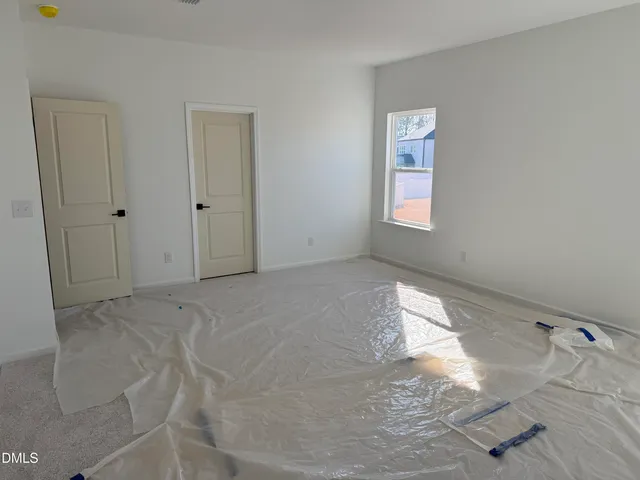 a spacious bathroom with a tub sink and mirror