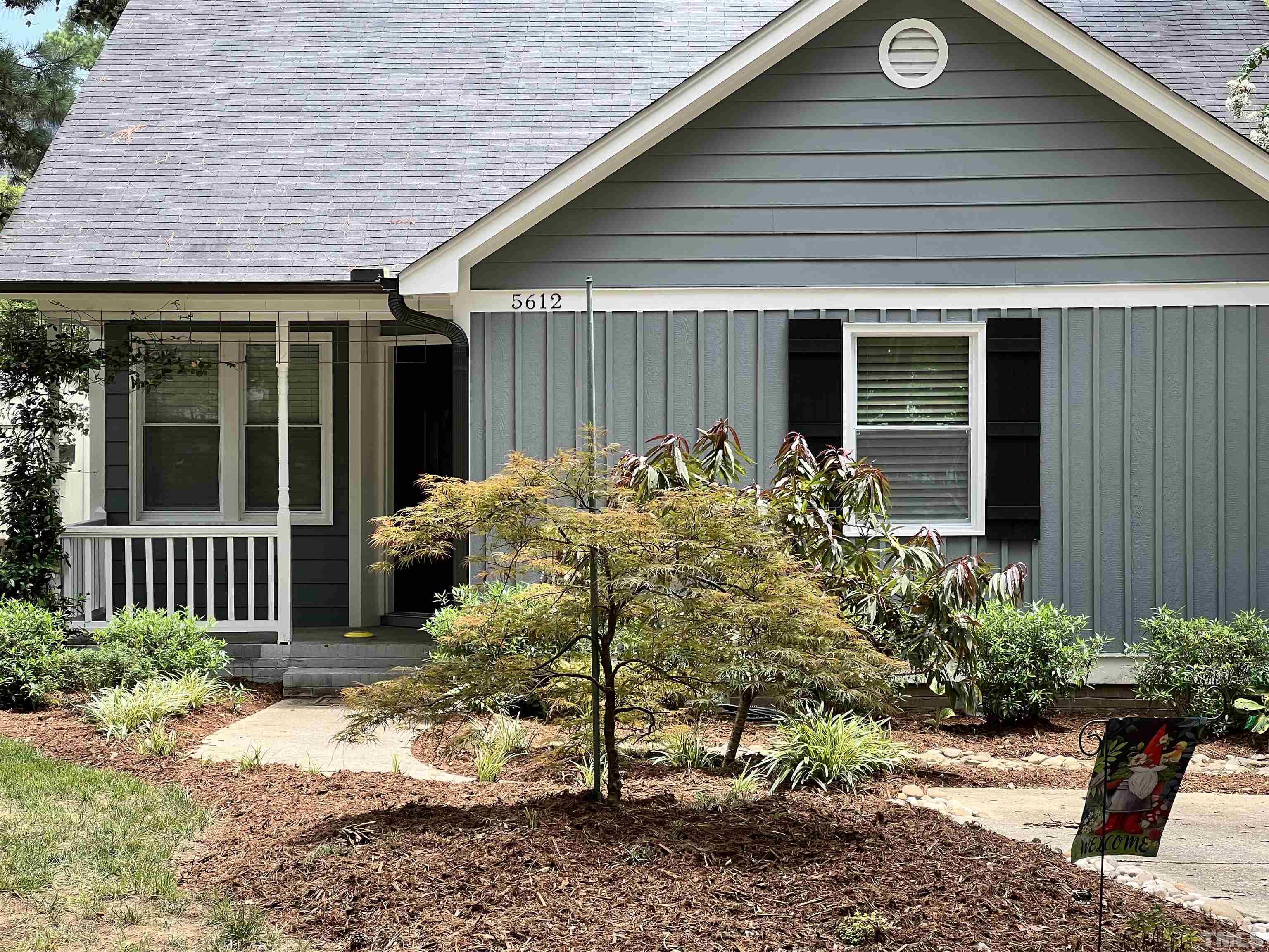 5612 Spring Pines Way Raleigh, NC 27616 - Photo 1 of 31 a flower garden is sitting in front of a house