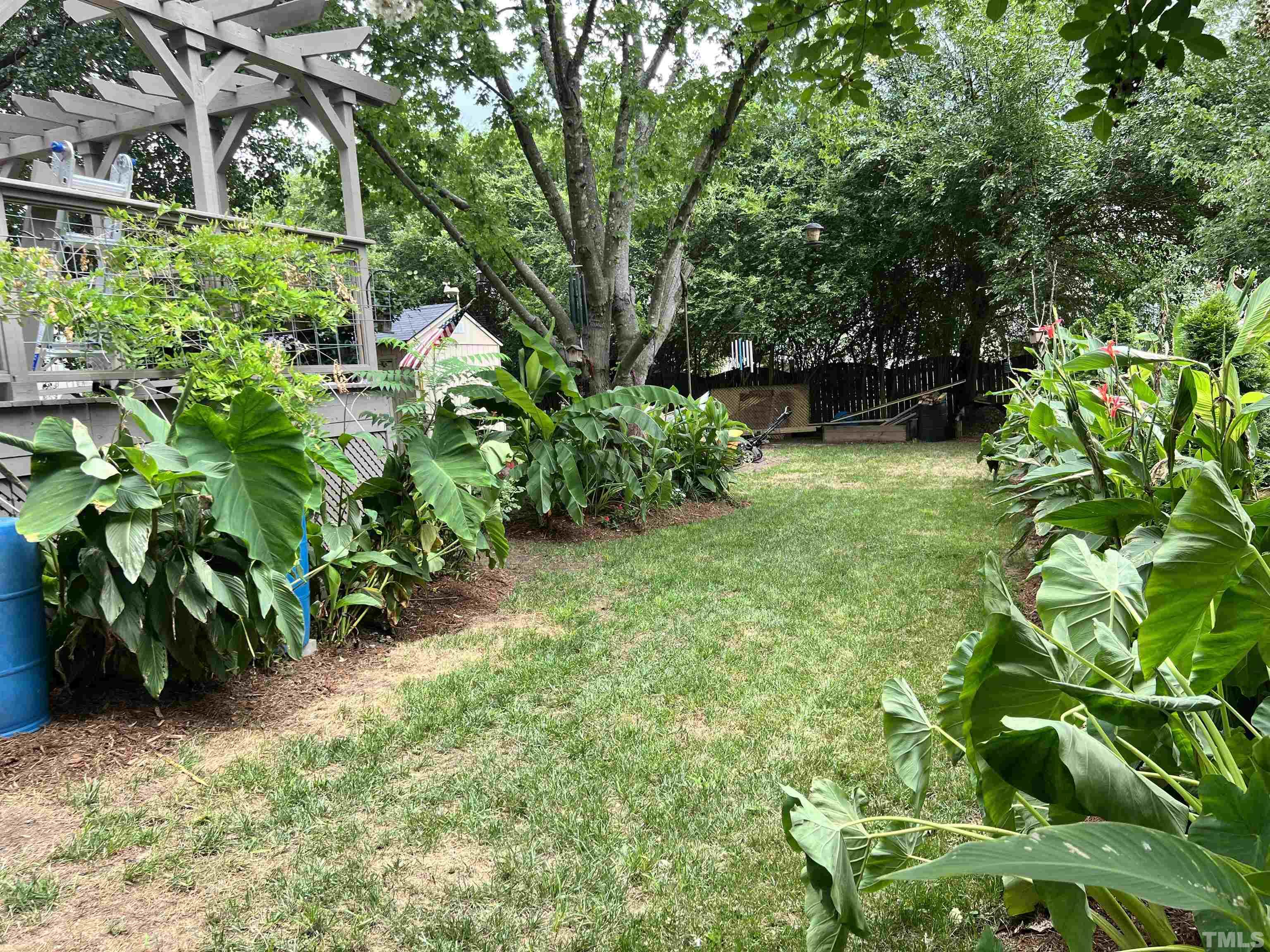 5612 Spring Pines Way Raleigh, NC 27616 - Photo 20 of 31 a backyard of a house with lots of green space