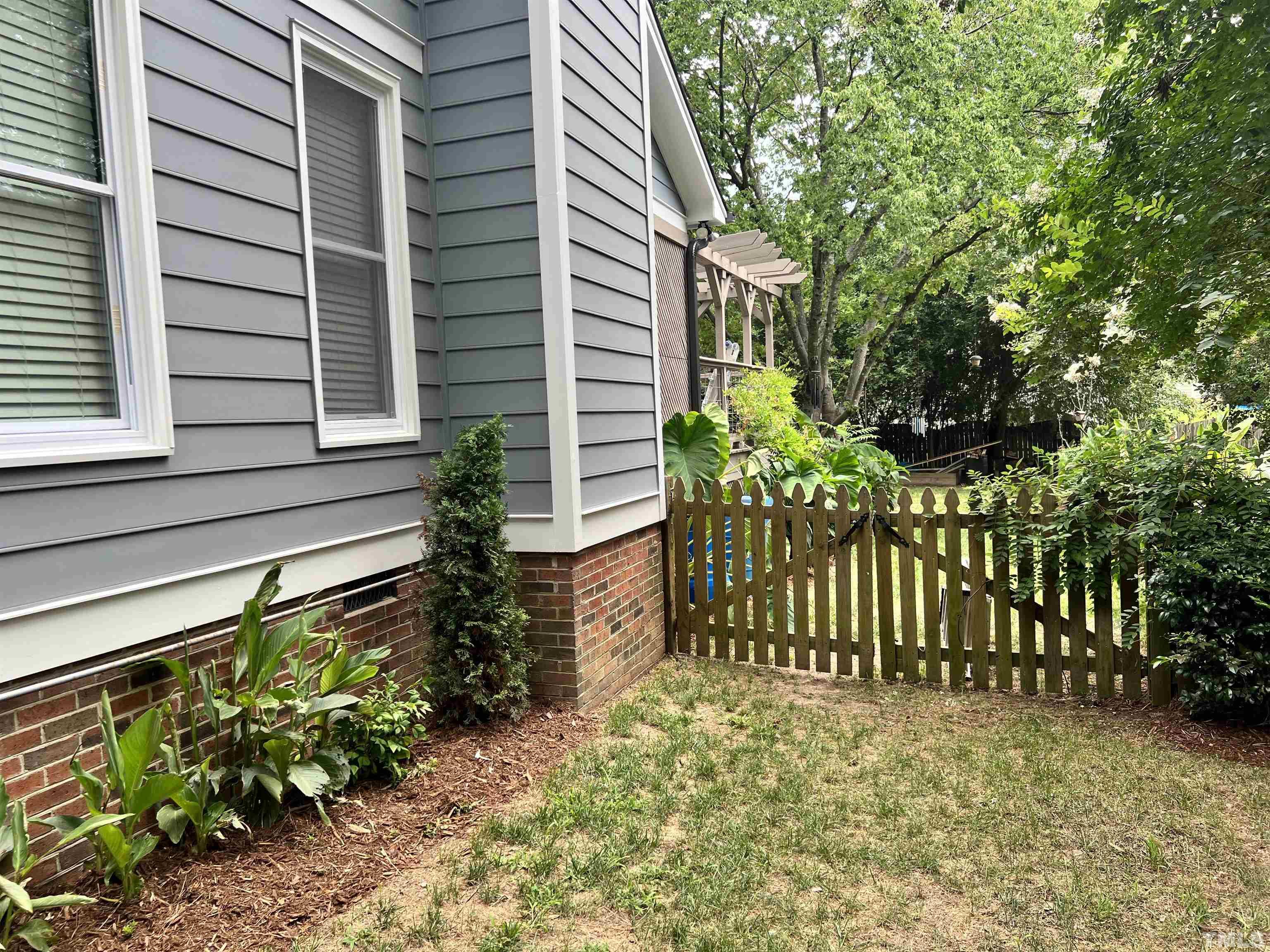 5612 Spring Pines Way Raleigh, NC 27616 - Photo 24 of 31 a view of a house with a flower garden