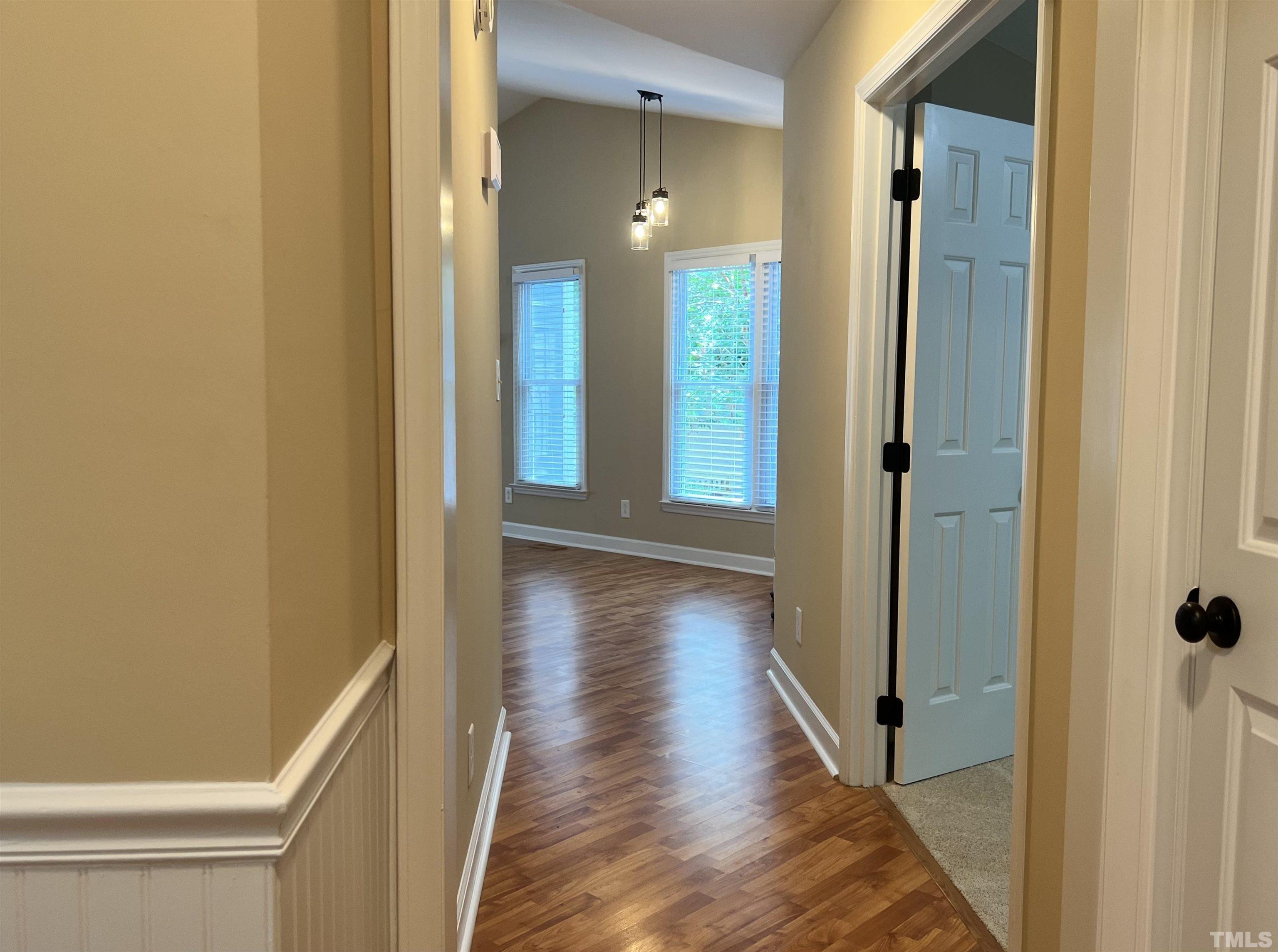 5612 Spring Pines Way Raleigh, NC 27616 - Photo 3 of 31 a view of a hallway with wooden floor and closet