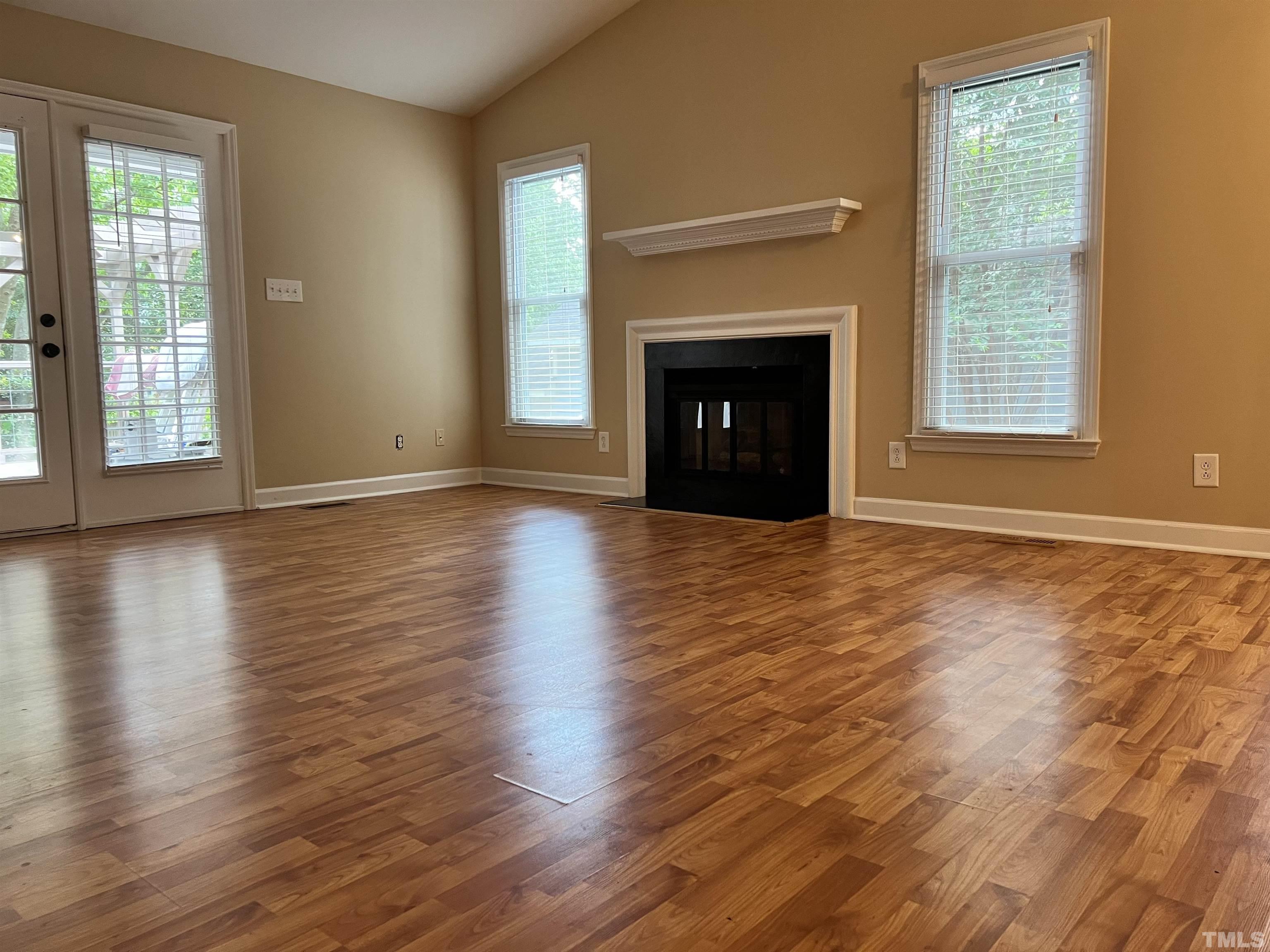 5612 Spring Pines Way Raleigh, NC 27616 - Photo 31 of 31 a view of empty room with wooden floor and fireplace