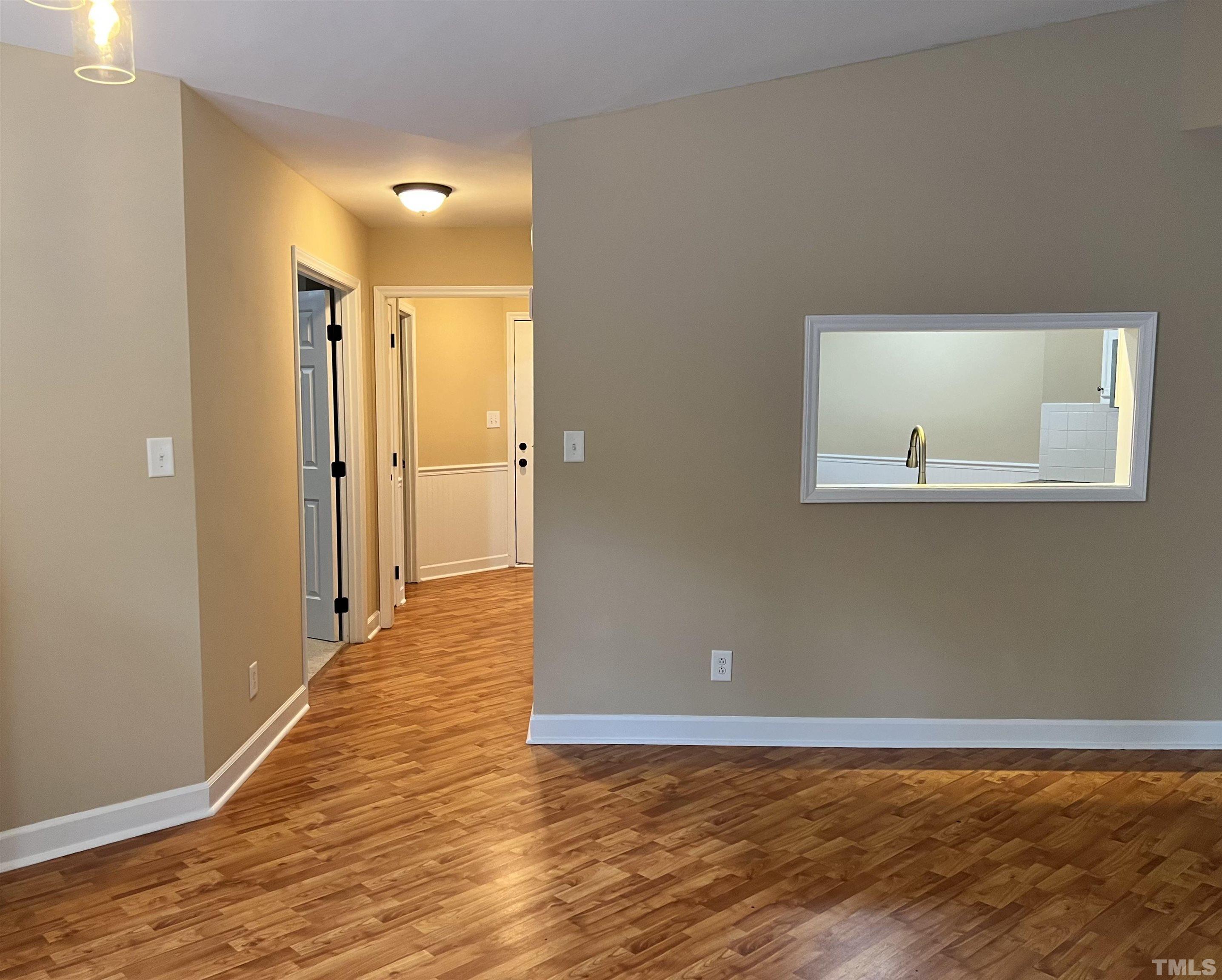 5612 Spring Pines Way Raleigh, NC 27616 - Photo 5 of 31 a view of a livingroom with wooden floor and a bathroom