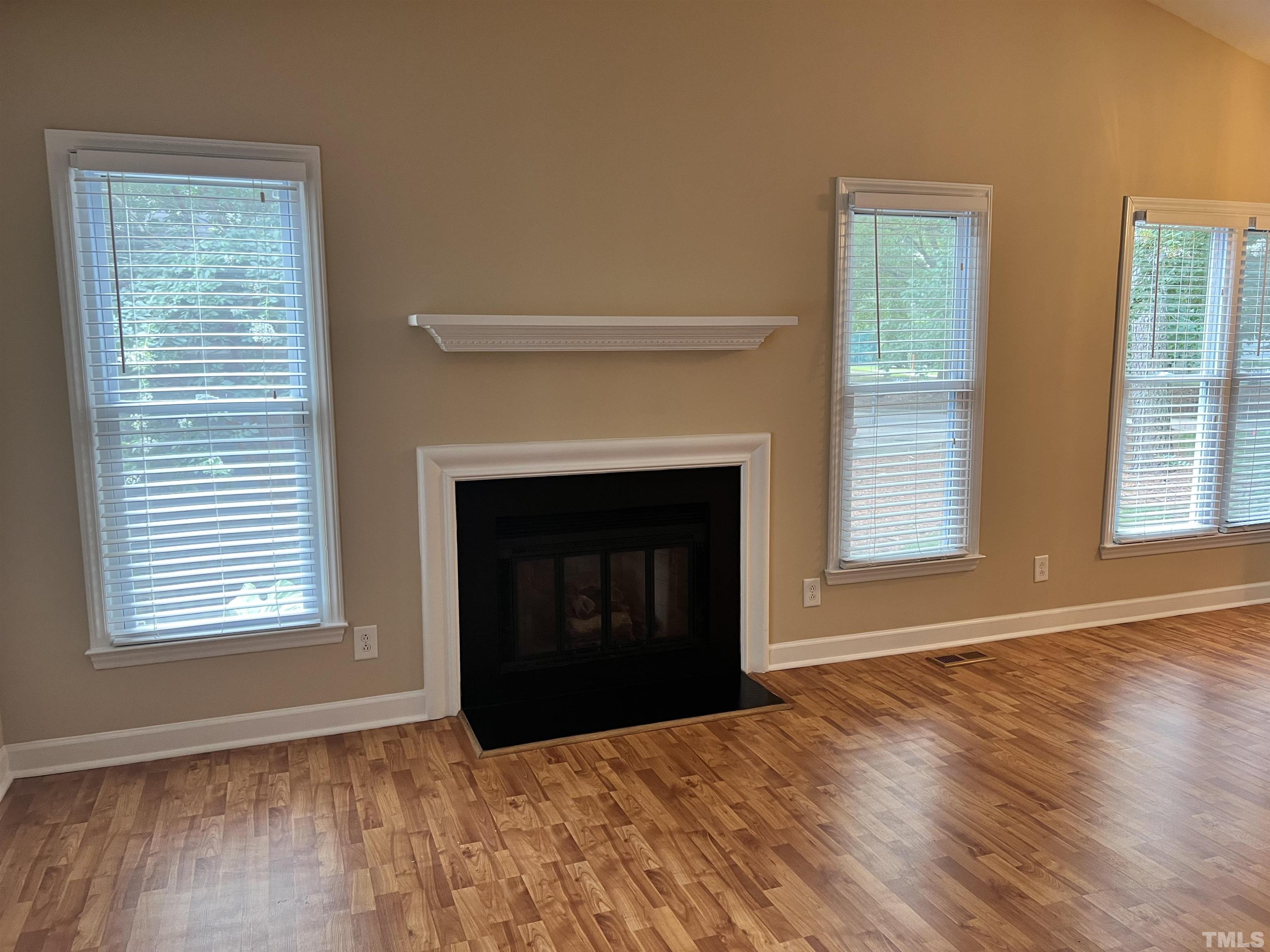 5612 Spring Pines Way Raleigh, NC 27616 - Photo 6 of 31 a view of an empty room with wooden floor and a window