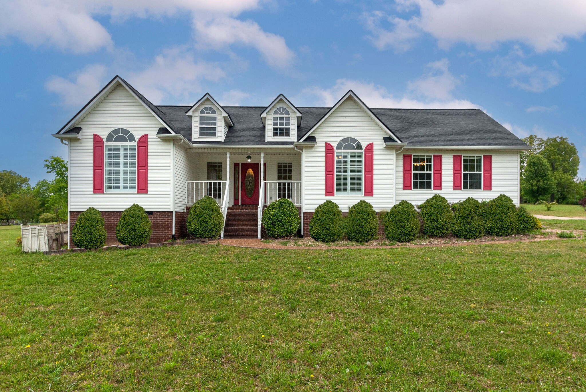 a front view of house with yard and green space