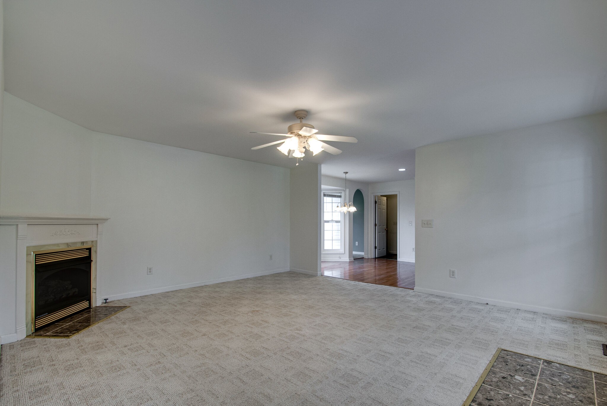 166 Caldwell Road Summertown, TN 38483 - Photo 11 of 36 a view of a room with chandelier fan and fireplace