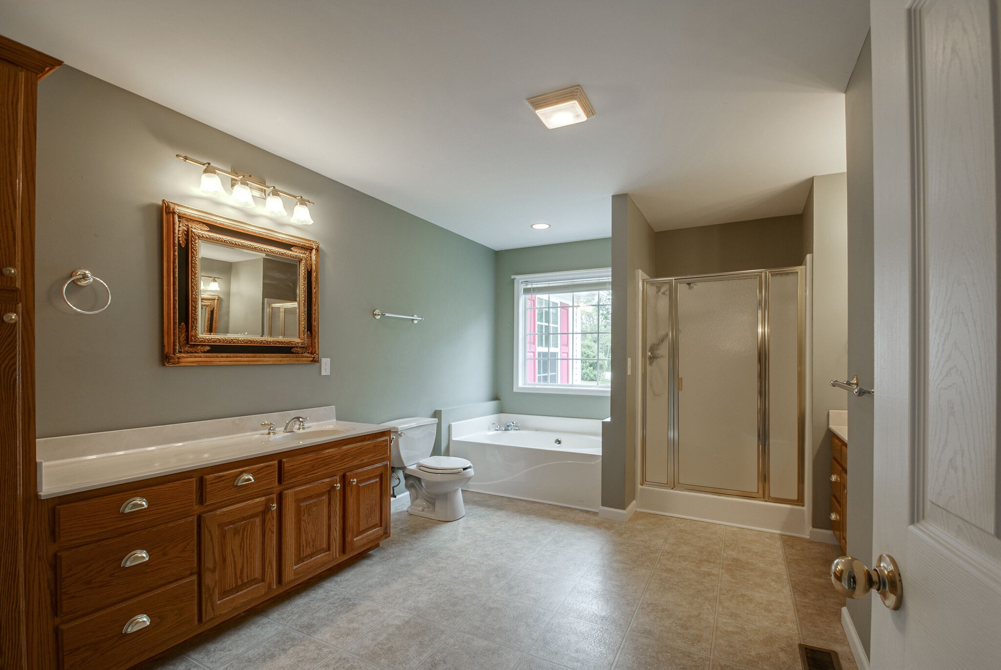 166 Caldwell Road Summertown, TN 38483 - Photo 22 of 36 a spacious bathroom with a double vanity sink a large mirror and a bathtub