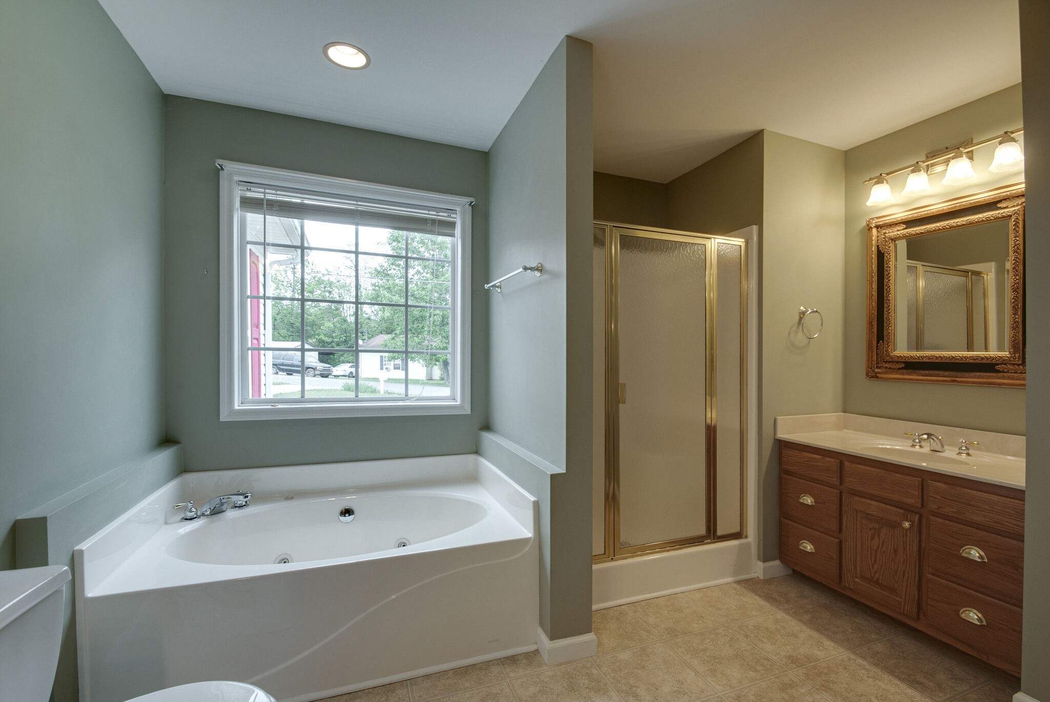 166 Caldwell Road Summertown, TN 38483 - Photo 23 of 36 a bathroom with a tub a sink double vanity and a shower
