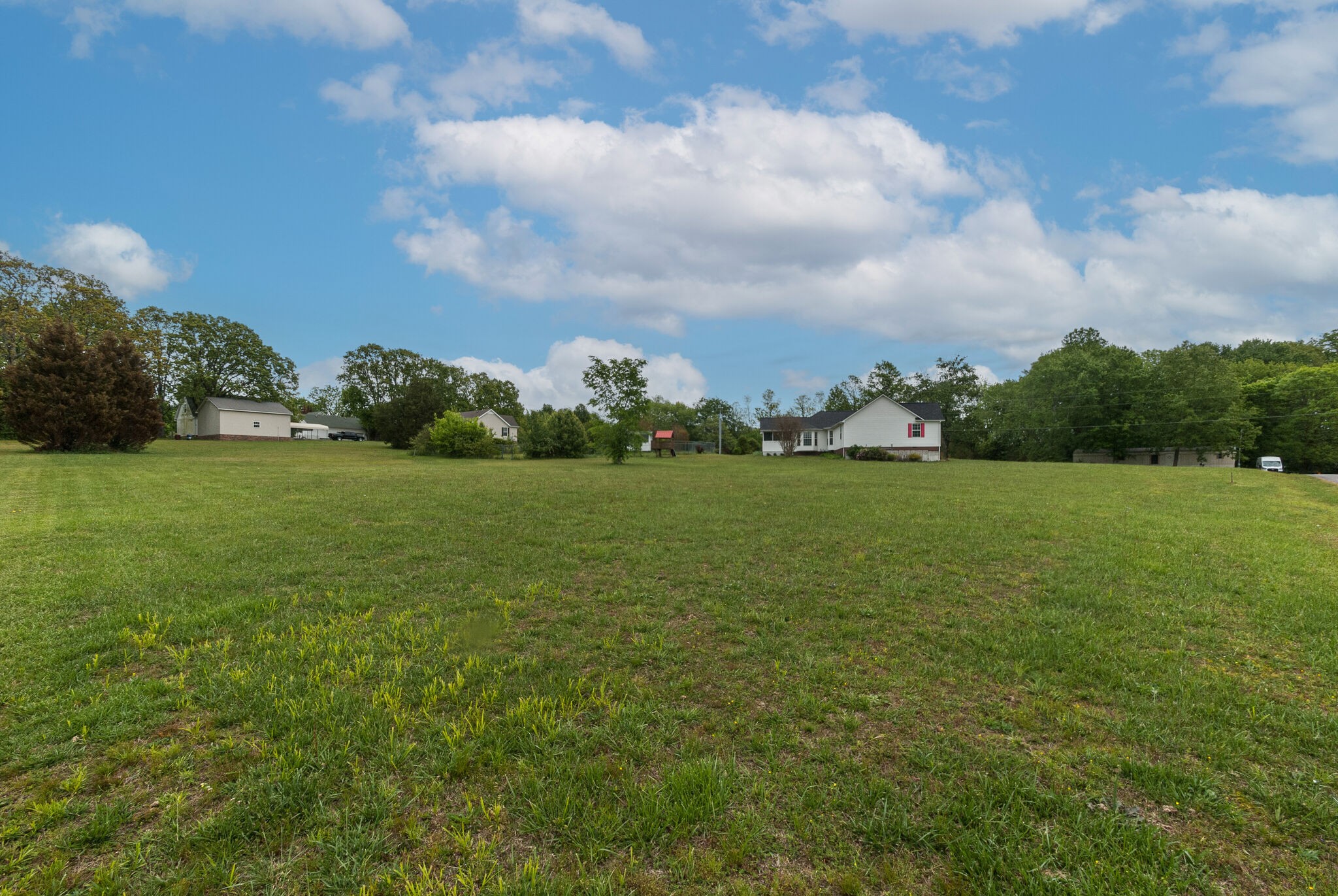 166 Caldwell Road Summertown, TN 38483 - Photo 36 of 36 a view of a garden with a building in the background