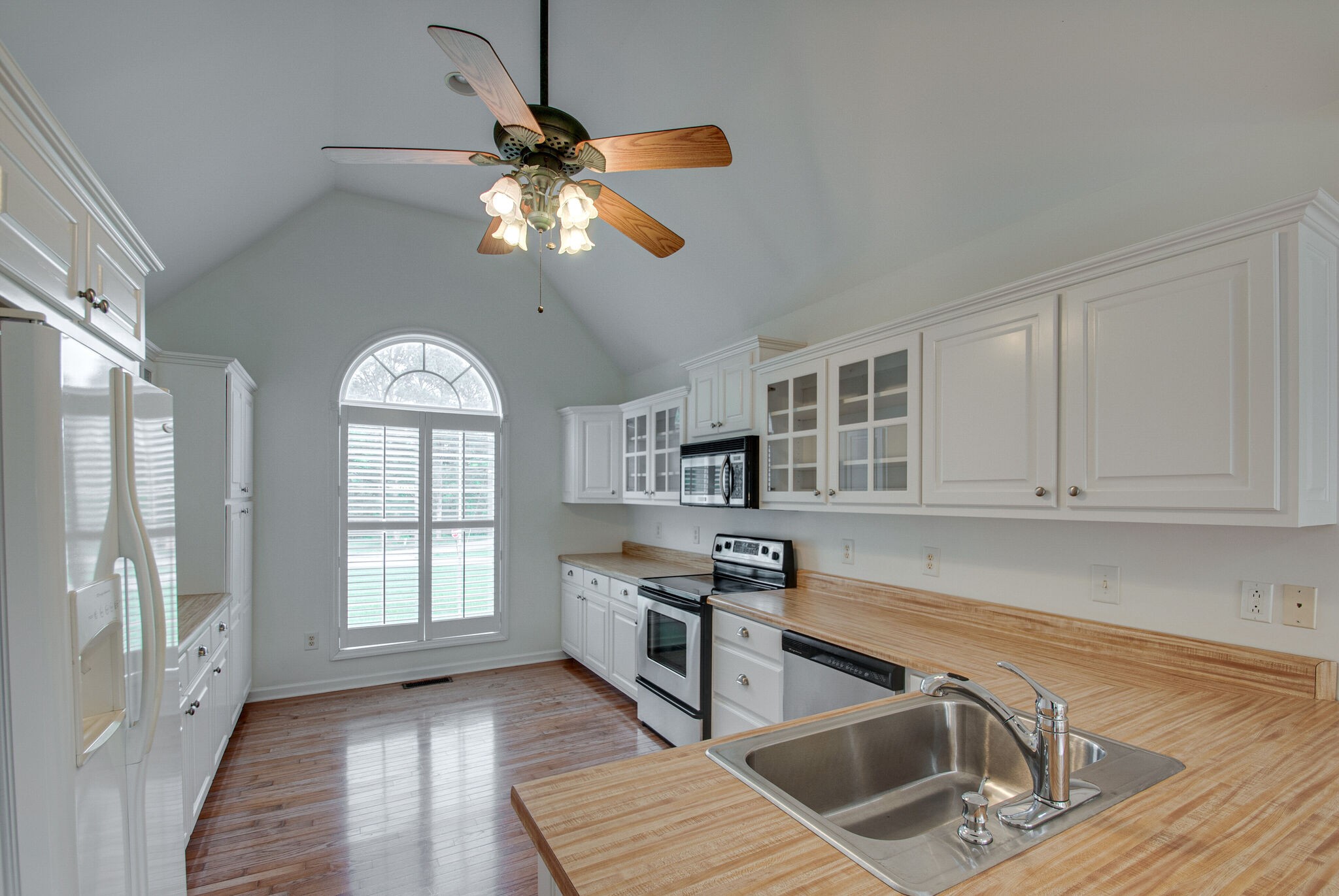 166 Caldwell Road Summertown, TN 38483 - Photo 7 of 36 a kitchen with stainless steel appliances granite countertop a stove a sink and a microwave