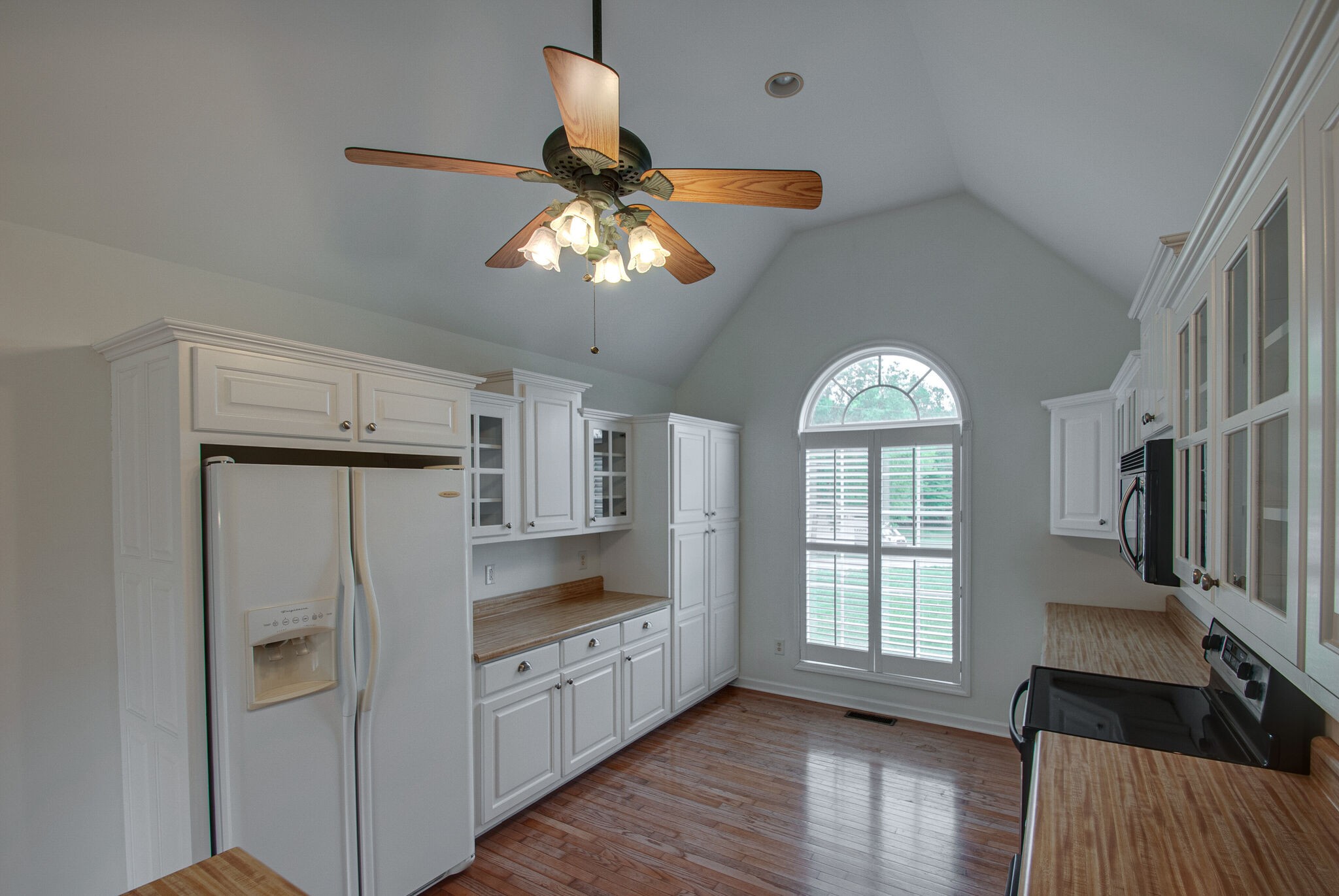 166 Caldwell Road Summertown, TN 38483 - Photo 8 of 36 a kitchen with stainless steel appliances a chandelier fan and wooden floor