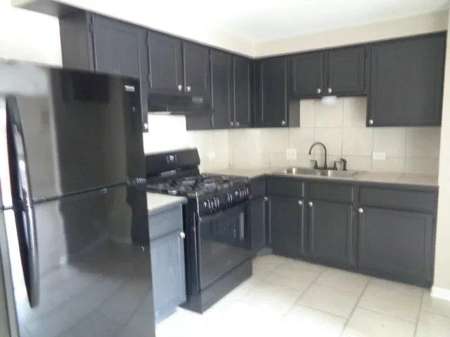 a kitchen with a sink and a refrigerator