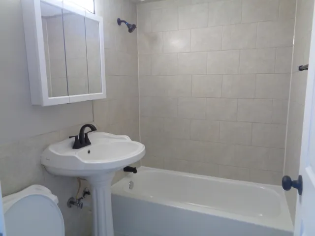 a bathroom with a sink a mirror and a bathtub