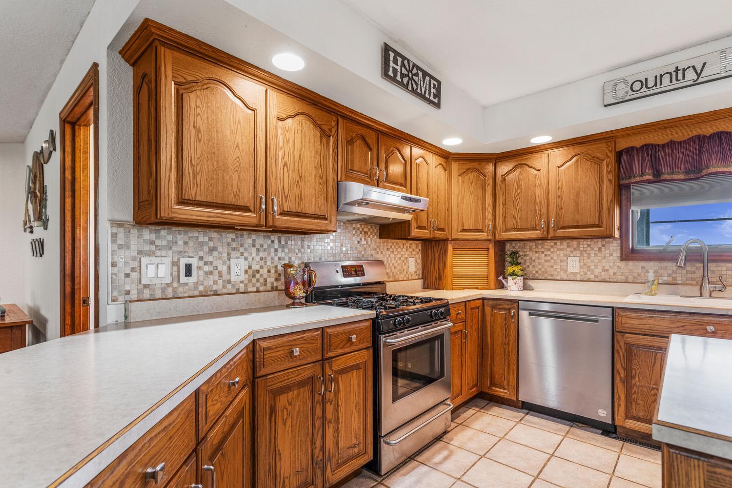 12317 North 1100 East Road Catlin, IL 61817 - Photo 12 of 44 a kitchen with stainless steel appliances granite countertop a sink stove and cabinets