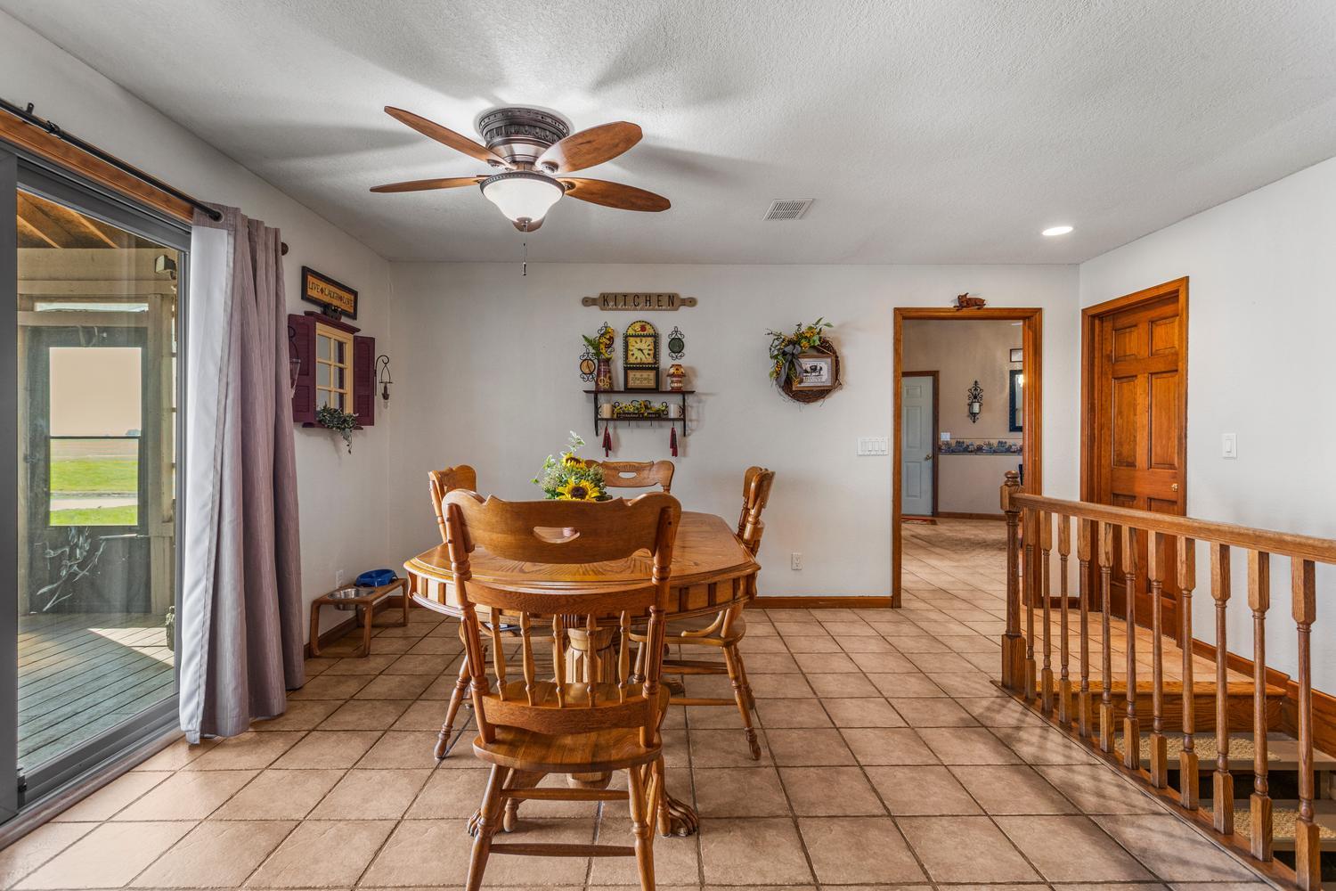 12317 North 1100 East Road Catlin, IL 61817 - Photo 15 of 44 a view of a dining room with furniture and a chandelier fan
