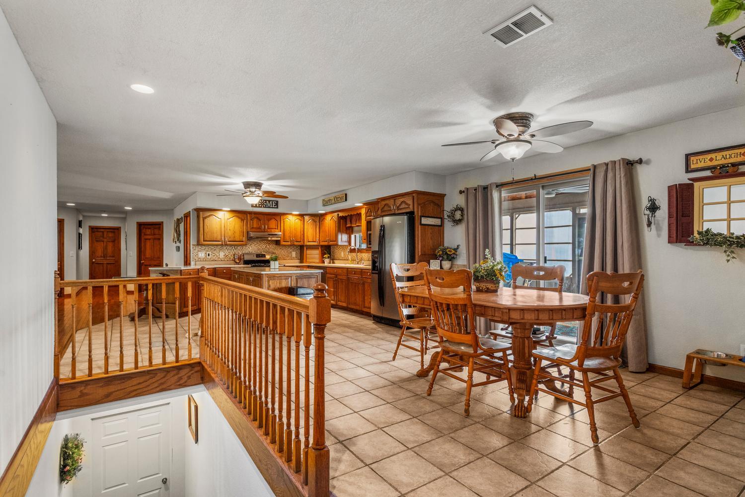 12317 North 1100 East Road Catlin, IL 61817 - Photo 16 of 44 a dining room with furniture a chandelier and wooden floor