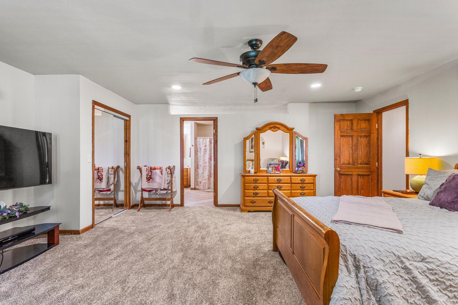 12317 North 1100 East Road Catlin, IL 61817 - Photo 24 of 44 a view of a livingroom with furniture a flat screen tv and a ceiling fan