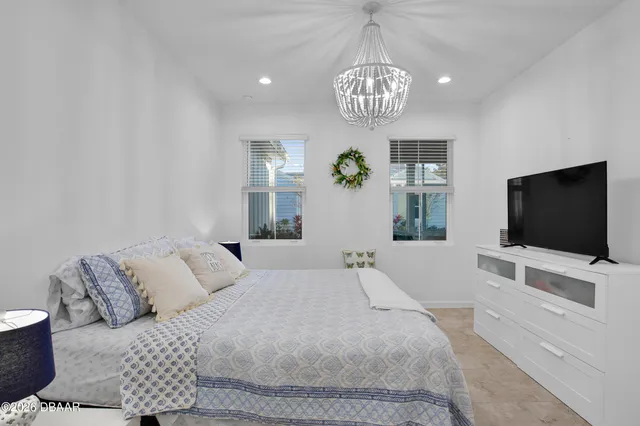 a bedroom with furniture and a flat screen tv