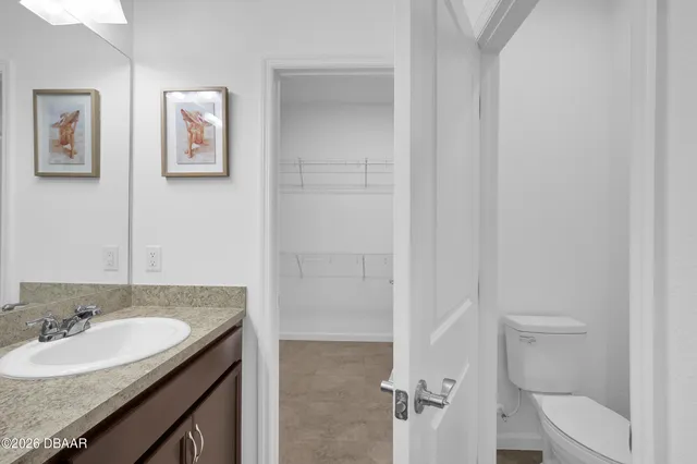 a bedroom with a bed mirror and a chandelier