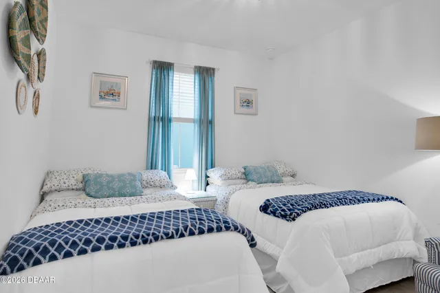 a bathroom with a sink a toilet a mirror and shower curtain