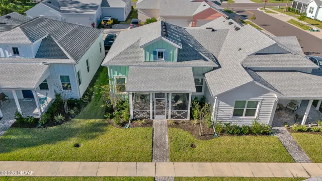 an aerial view of a house with backyard and trees