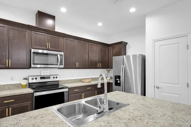 a kitchen with a refrigerator and a sink