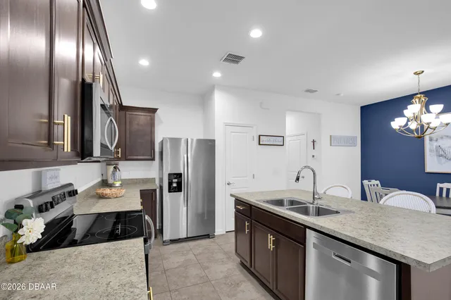 a kitchen with a sink and refrigerator