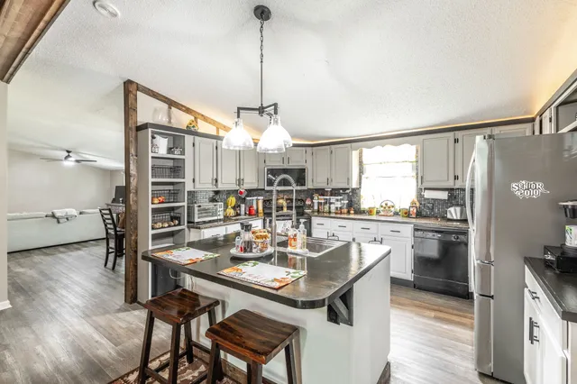 a kitchen with a table chairs refrigerator and cabinets