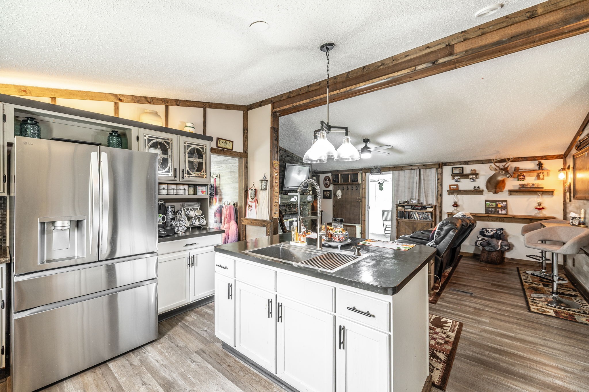 5776 Craft Road Joelton, TN 37080 - Photo 13 of 57 a kitchen with stainless steel appliances kitchen island granite countertop a refrigerator and microwave