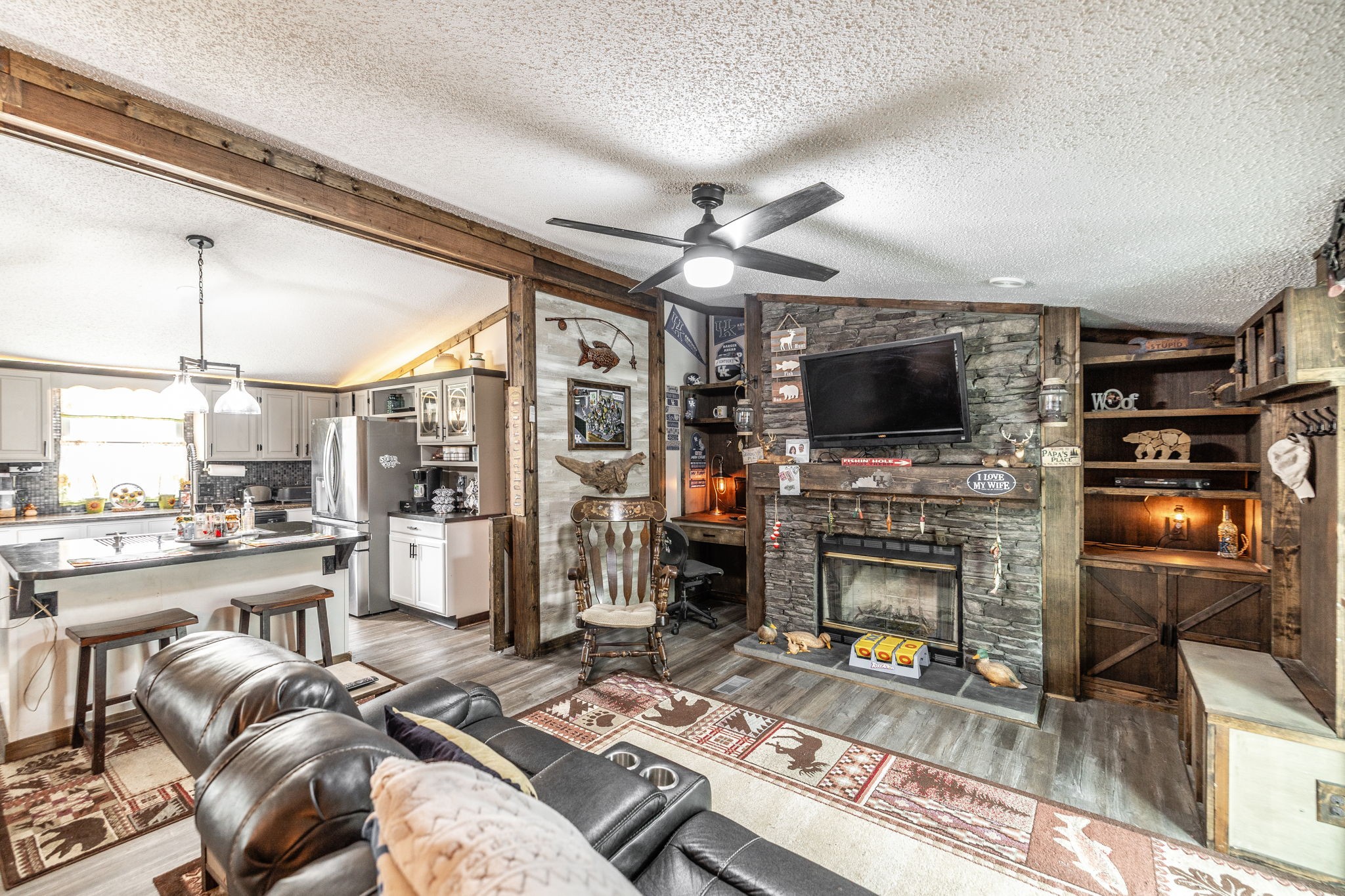 5776 Craft Road Joelton, TN 37080 - Photo 16 of 57 a living room with furniture a flat screen tv and a fireplace