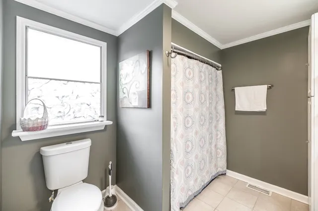 a bedroom with a bed and a book shelf