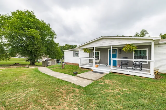 a front view of a house with a yard table and chairs