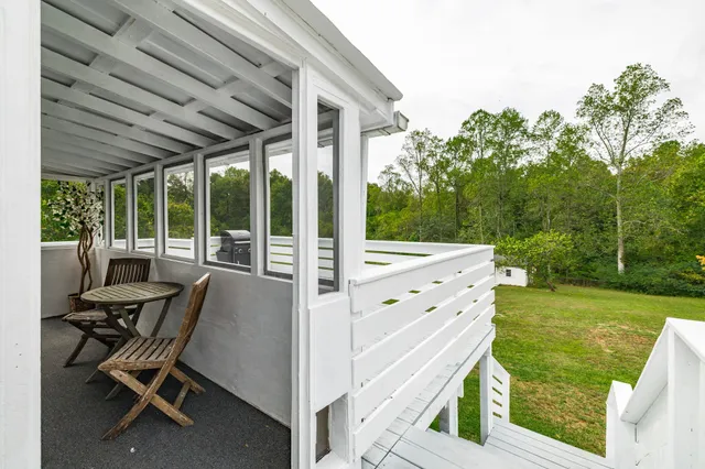 a view of a balcony with wooden floor and outdoor space