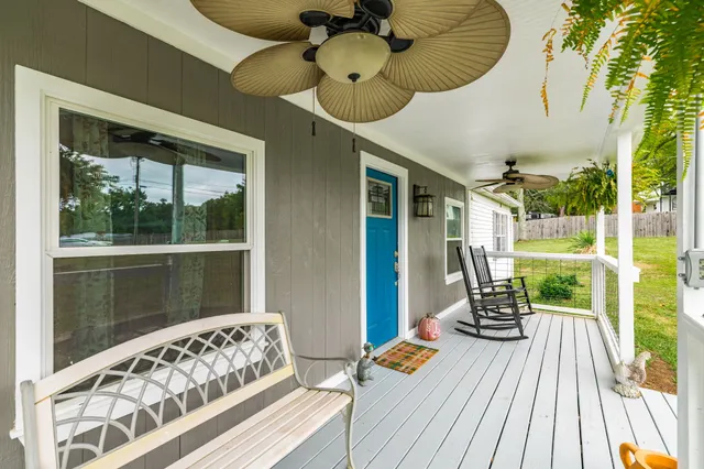 a view of a balcony with chair and wooden floor