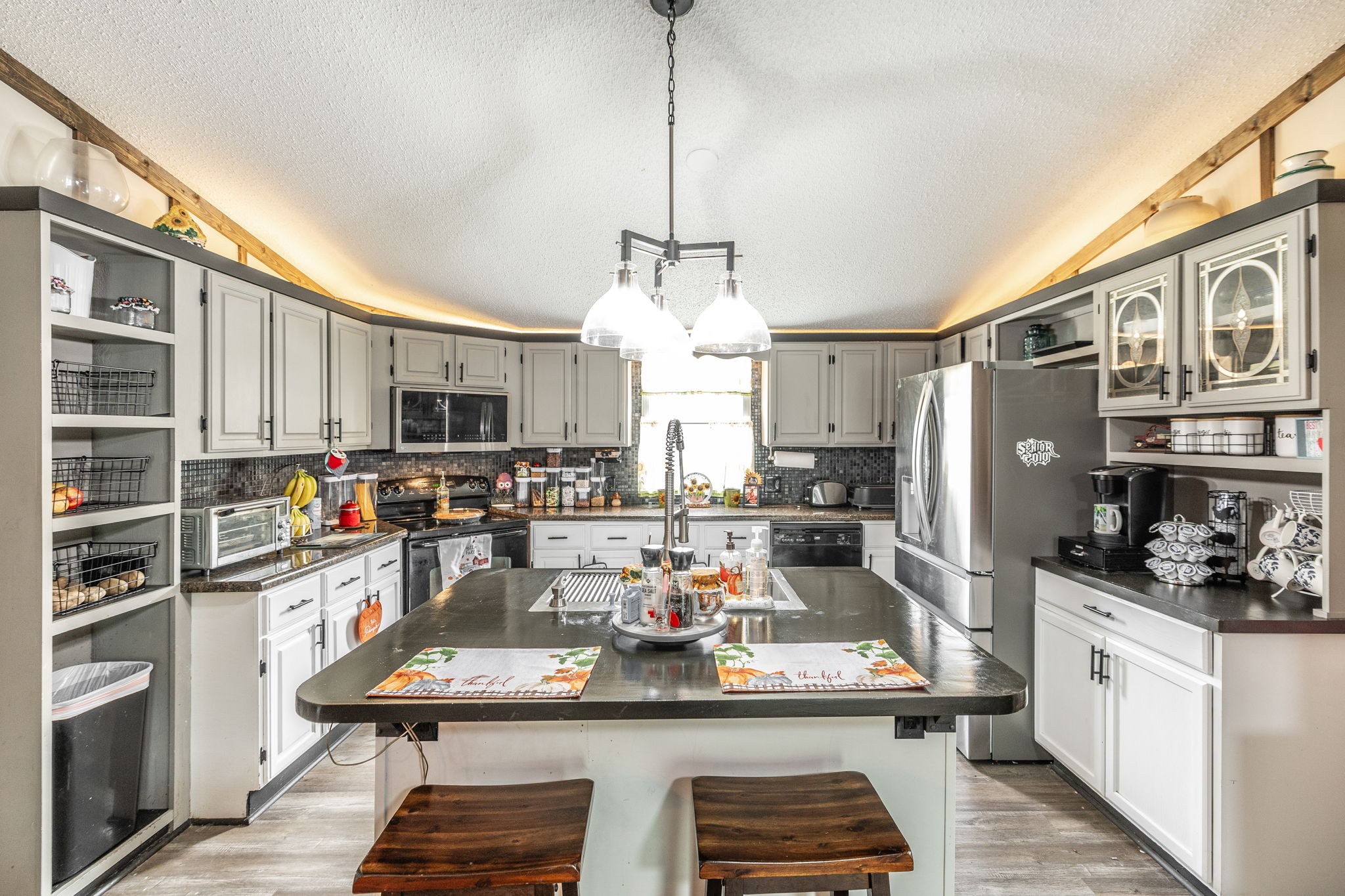 5776 Craft Road Joelton, TN 37080 - Photo 10 of 57 a kitchen with stainless steel appliances kitchen island granite countertop a stove and cabinets