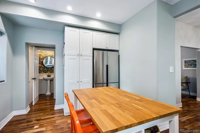 a very nice looking bedroom with a large bed and wooden floor