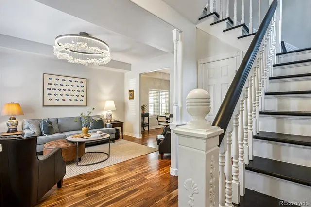 a living room with furniture a rug and a chandelier