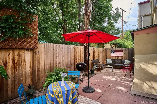 an outdoor space with furniture and umbrella