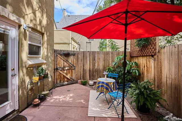 a view of a with tables and chairs under an umbrella in the patio