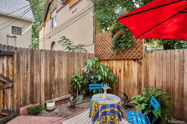 a view of front door with potted plants
