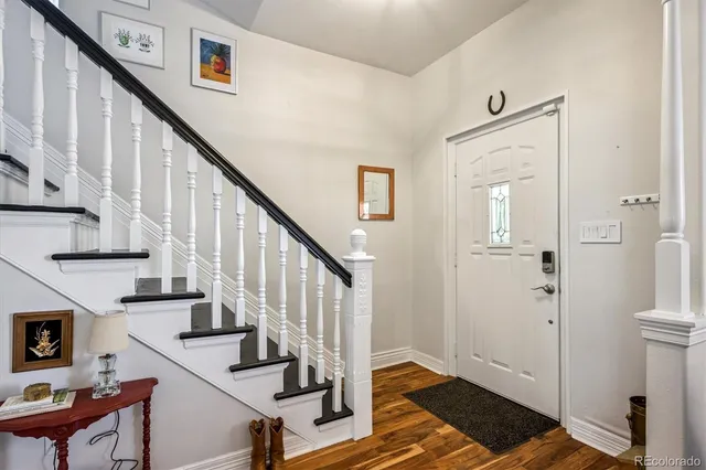 a view of entryway and hall with wooden floor