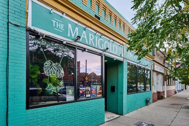 a front view of a building with a garden