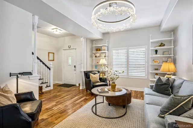 a living room with furniture a clock and a window