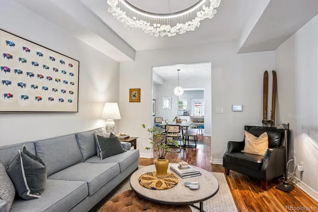a living room with furniture a clock and a large mirror