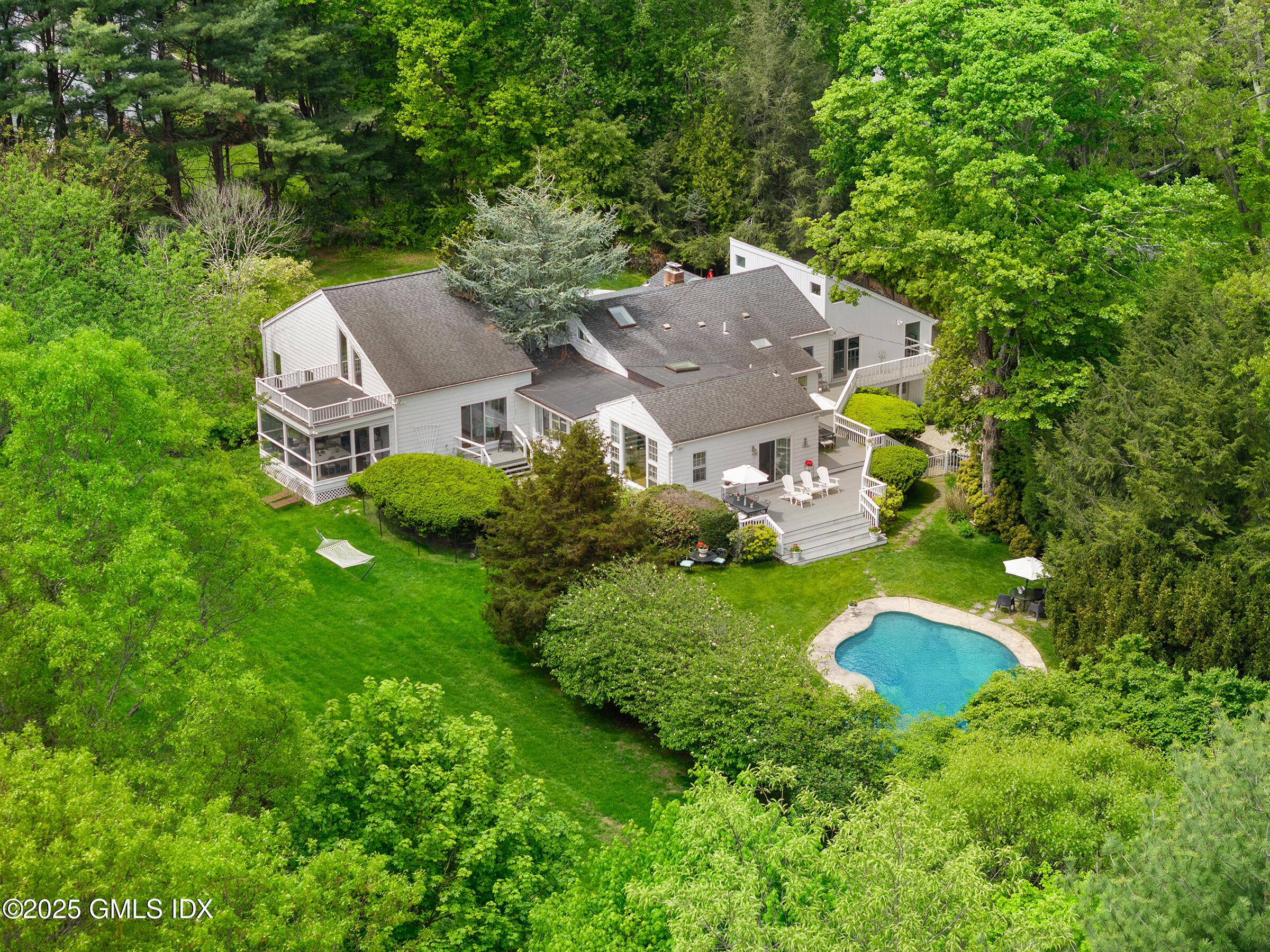 an aerial view of a house with yard swimming pool and outdoor seating