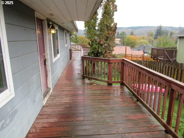 a view of a balcony with wooden floor