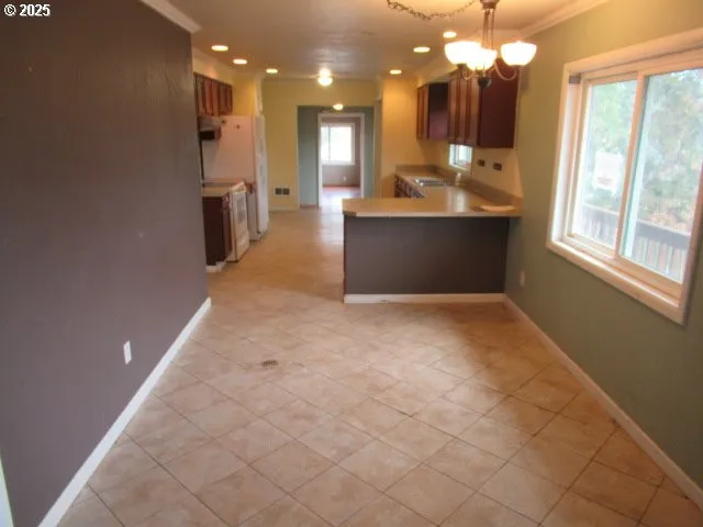 a view of kitchen with granite countertop cabinets and outdoor view
