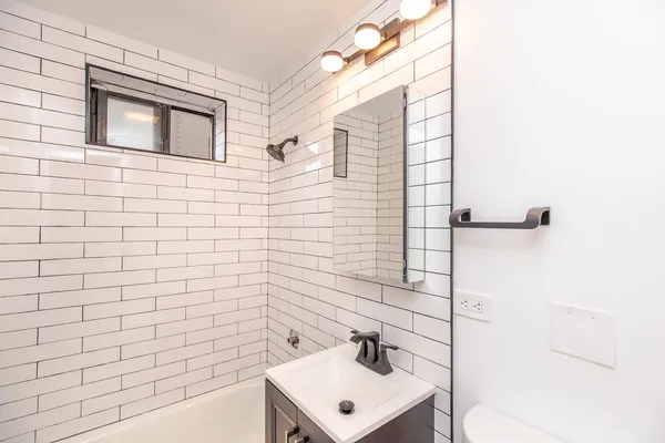 a bathroom with a sink a mirror and shower