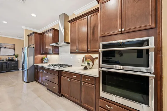 a kitchen with stainless steel appliances granite countertop a stove microwave and refrigerator