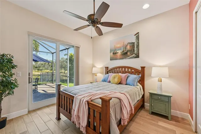a bedroom with a large bed and a chandelier
